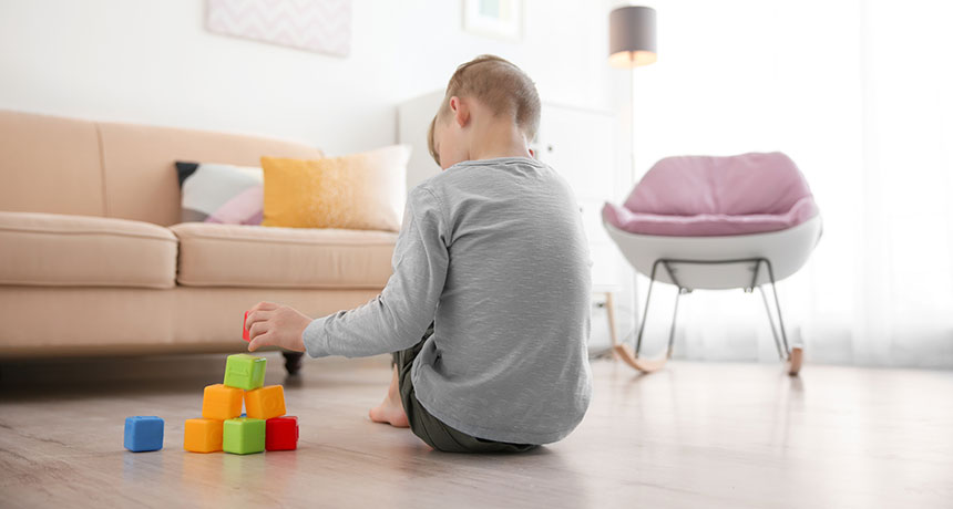 a child playing with blocks on the floor