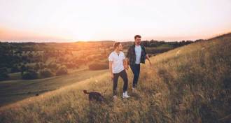 gay couple walking in a field