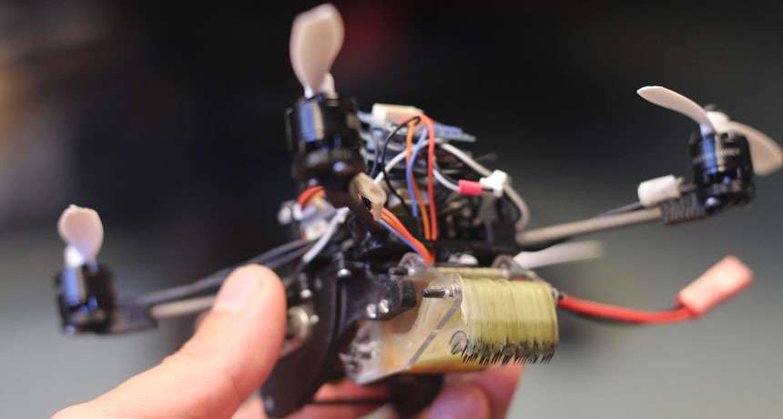 a photo of a small drone held in a person's hand