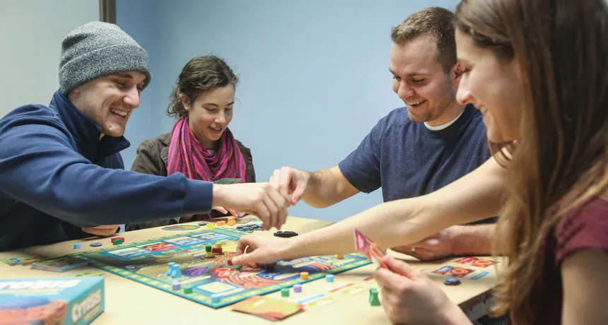 people playing a science board game