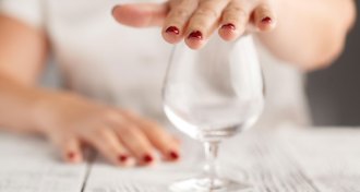 person covering wine glass