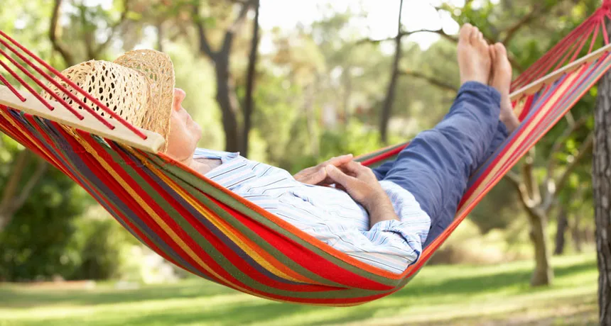 person snoozing in a hammock