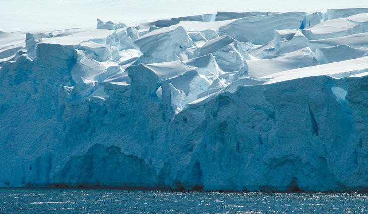 a photo of a glacier on Anvers Island jutting into the ocean