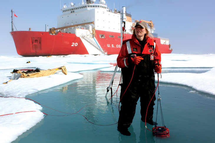 polar scientist Karen Frey stands in a melt pond