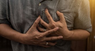person grasping their chest