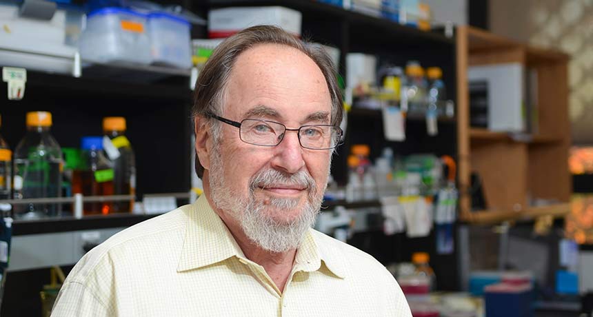 a photo of David Baltimore in a lab