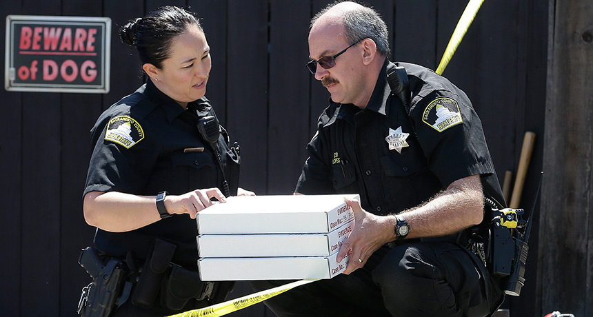 police officers with evidence boxes