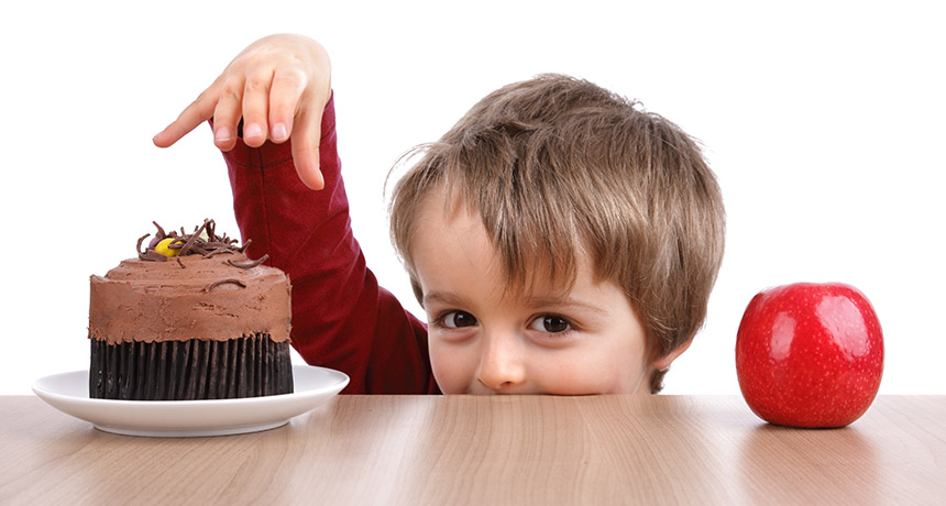 little kid choosing between cake or apple