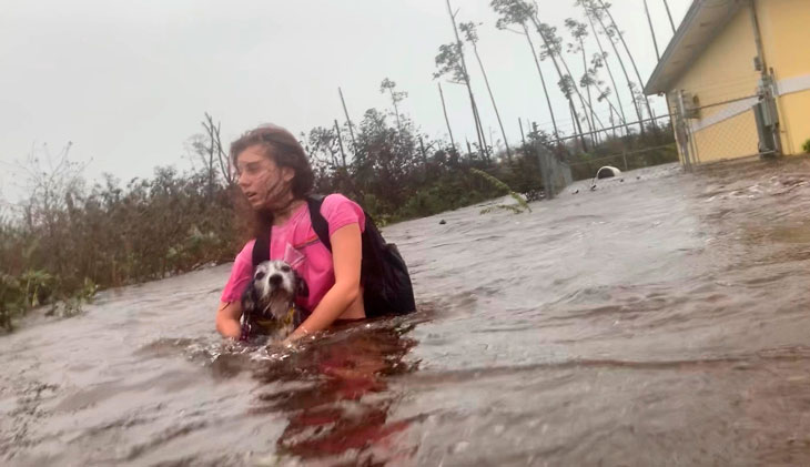 woman carrying dog in Bahamas