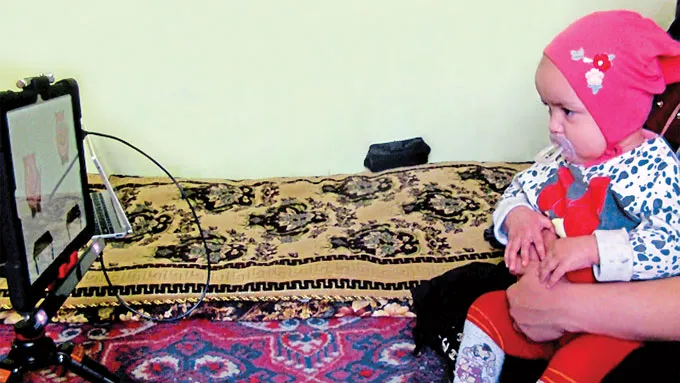 Tajik child watches cartoon
