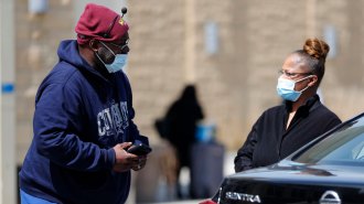two people wearing masks