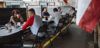 people sitting at distanced tables in a restaurant