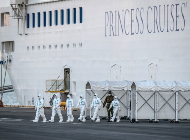 photo of people leaving cruise ship in hazmat suits