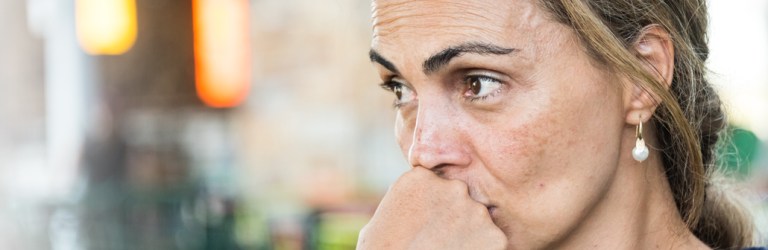 woman staring off to the side looking troubled