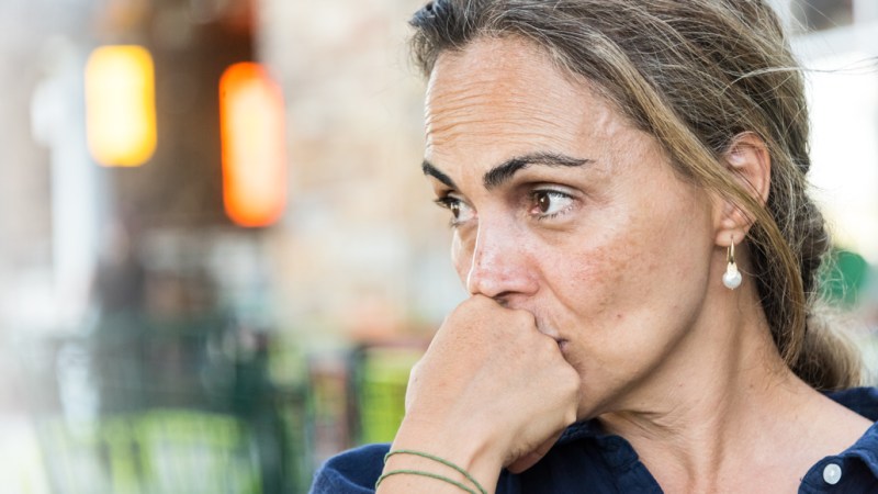 woman staring off to the side looking troubled