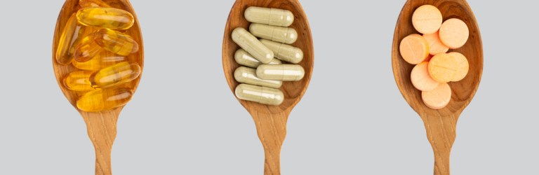 supplement pills in spoons