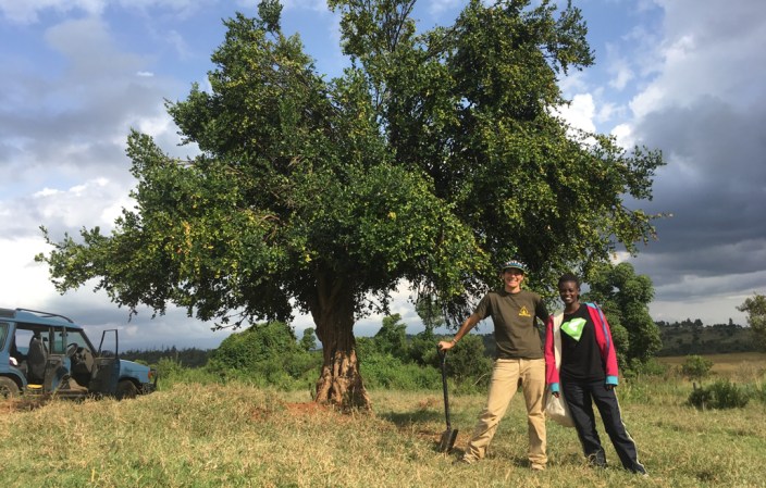 researchers in front of an African arrow poison tree