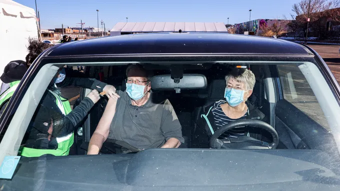 Jack Cook recieving his covid-19 vaccine shot in his car