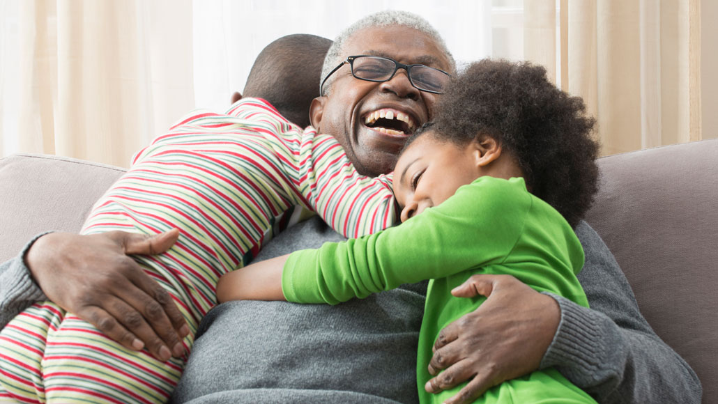 children hugging happy older person