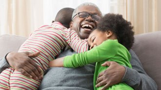 children hugging happy older person