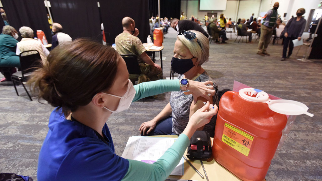 person getting vaccinated at mass vaccination site