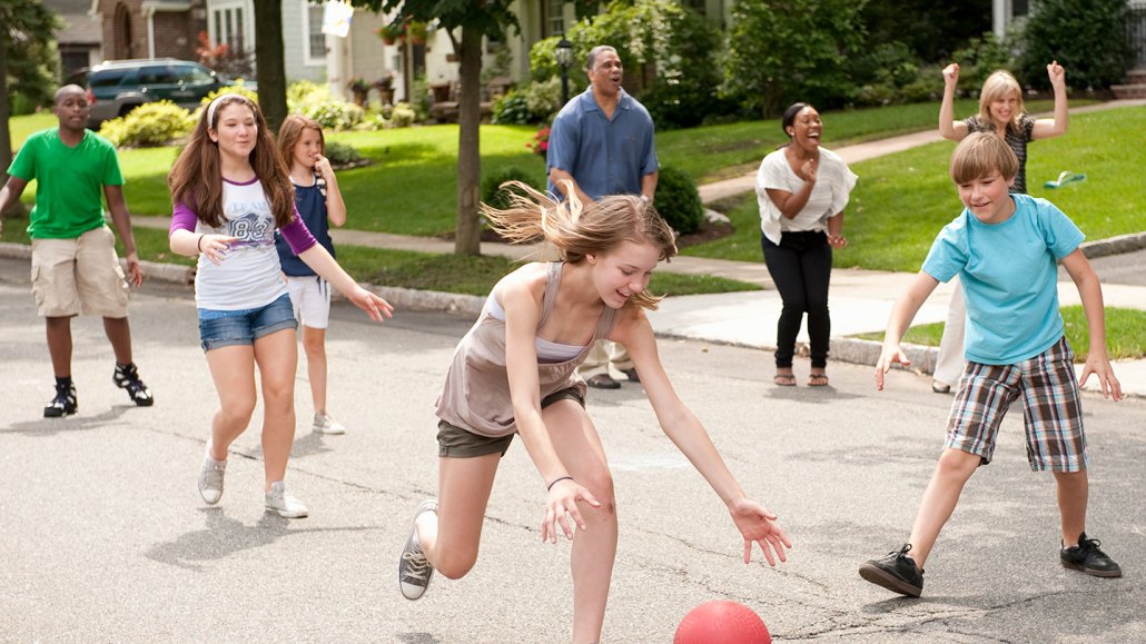 black and white people playing in the street