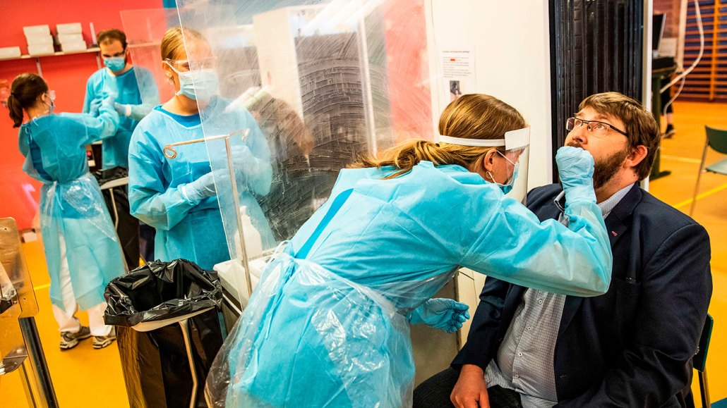 medical staff taking covid test samples from people at a hospital in Denmark