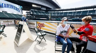 woman receiving a covid-19 vaccine dose at Seattle Mariners's stadium