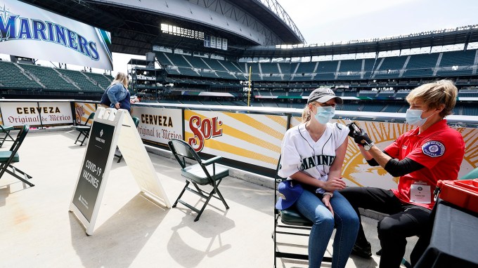 woman receiving a covid-19 vaccine dose at Seattle Mariners's stadium