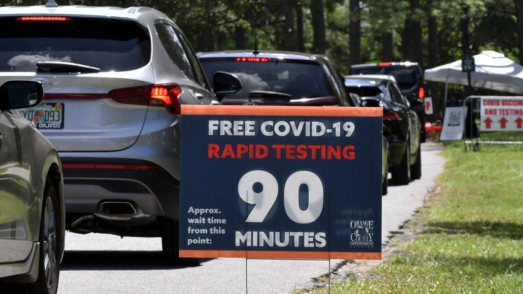 cars lined up at a COVID-19 rapid testing site