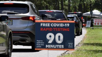 cars lined up at a COVID-19 rapid testing site