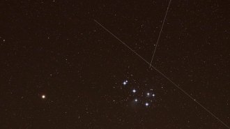image of Mars and the Pleiades star cluster with crisscrossing streaks from Starlinks satellites