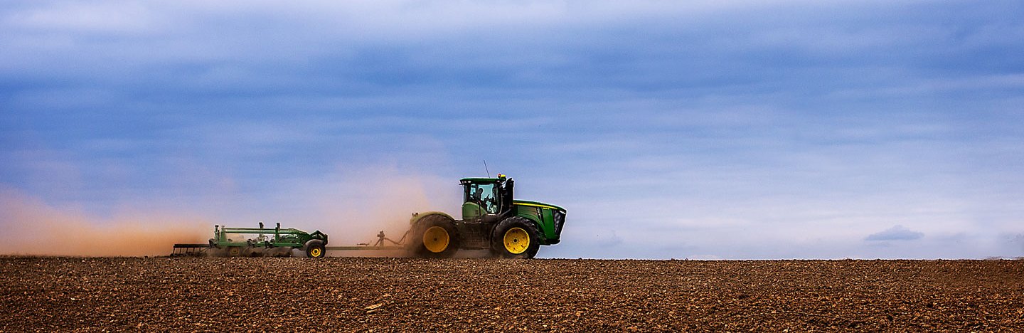 photo of a tractor tilling a field