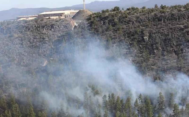 Los Alamos Neutron Science Center with smoke in the foreground