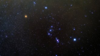 image of a bright red star on the left (Betelgeuse) amid the rest of the constellation Orion (other stars in blue)