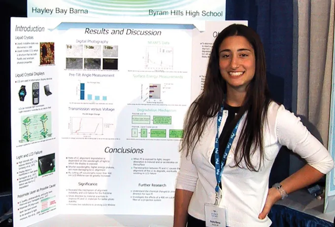 Hayley Bay Barna stands in front of a poster