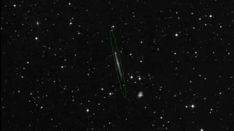 A photo of stars with Galaxy IC 5249 in the center with a green oval around it.