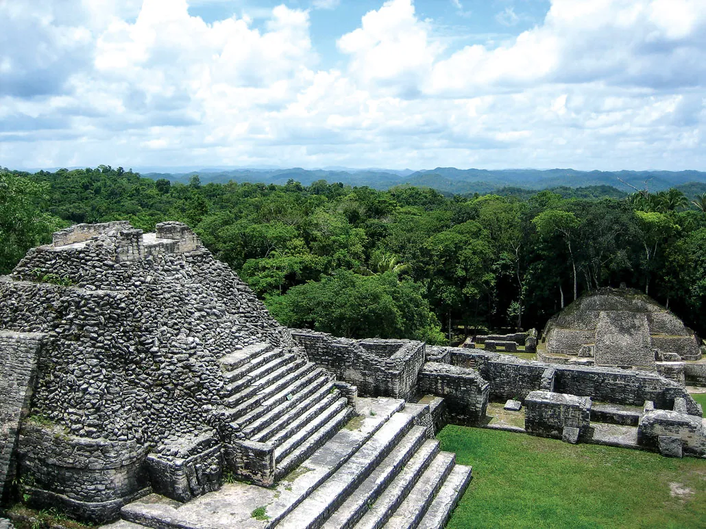 A stone pyramid complex at Caracol with the forest in the background