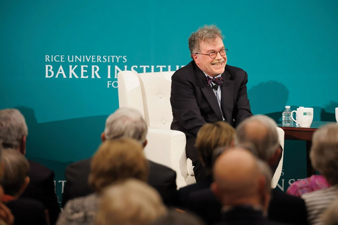 Dr. Peter Hotez sits in a chair in front of a crowd at Rice University's Baker Institute for Public Policy in Houston.