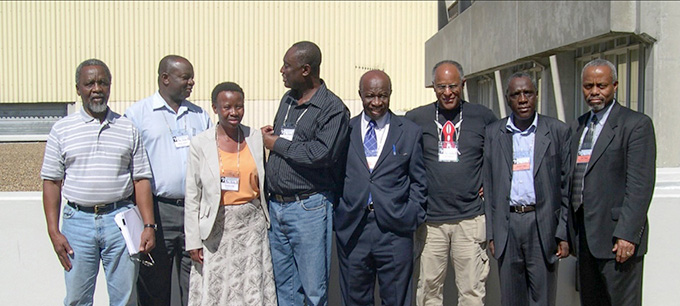 Sekazi Mtingwa and other researchers stand outside a building in South Africa