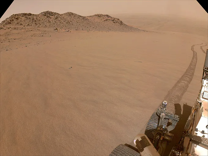 A sandy slope with part of a robot vehicle is shown