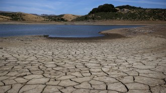 Dry, cracked earth rings a depleted reservoir in California after many years of drought.