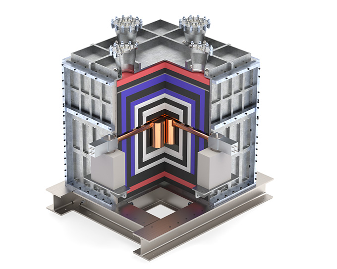 A computer rendering shows two small copper-colored cylinders surrounded by a layered cube of other material.