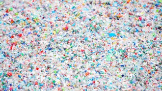 Colorful bits of plastic are spread across the image.