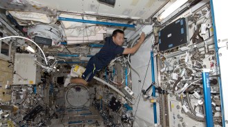 image of astronaut cleaning space station