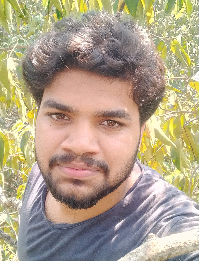 A selfie of ecologist Akhil Javad among trees