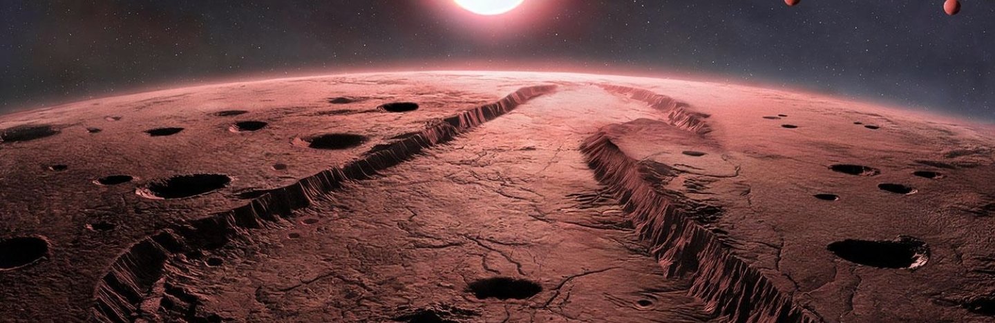 A red sun and three planets hang over the horizon of a red rocky planetary surface.