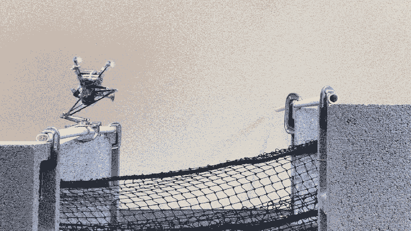 A jumping robot with one leg leaps from one PVC pipe to another. A black net is strung below it.