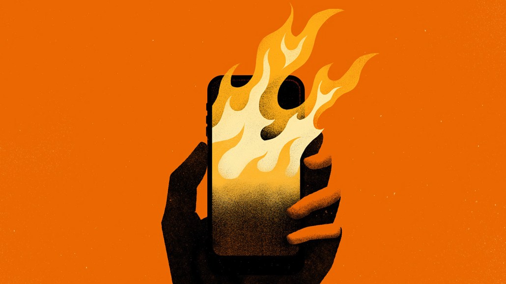 Illustration of a hand holding a smartphone engulfed in flames, symbolizing the spread of climate misinformation.