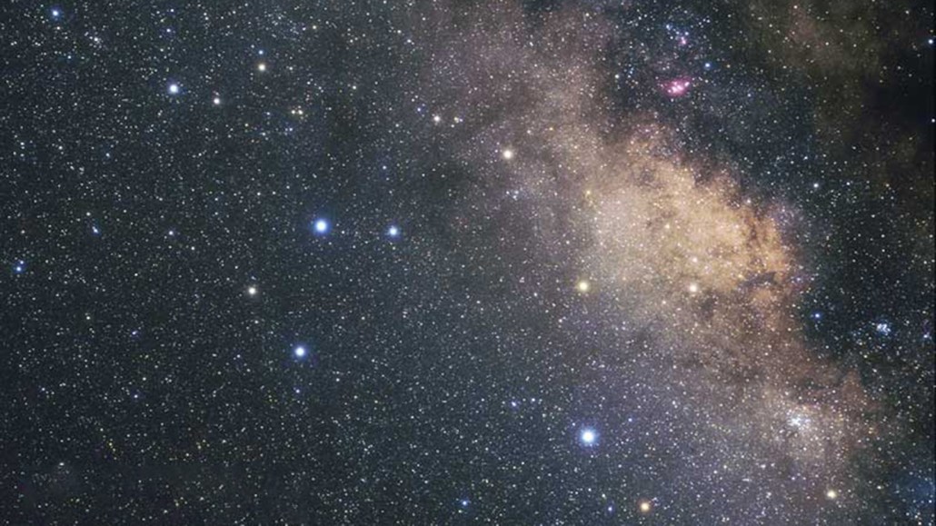 An image of the constellation Sagittarius shows a star-dotted expanse of space. There is a lone black hole (not visible) on the loose in the region.
